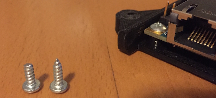 Sheet metal screws (#4). Left screw was shortened with a Dremel.